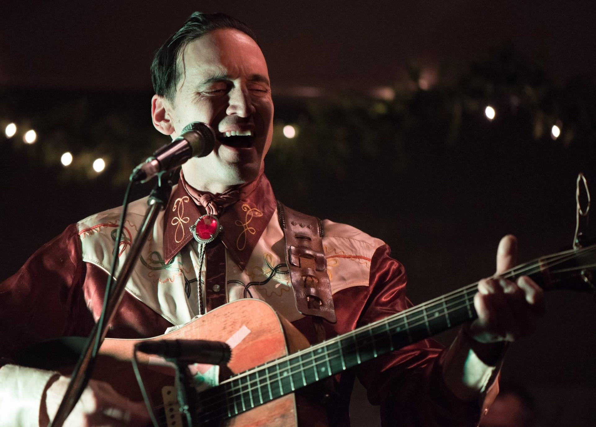 Playing the guitar and singing.
