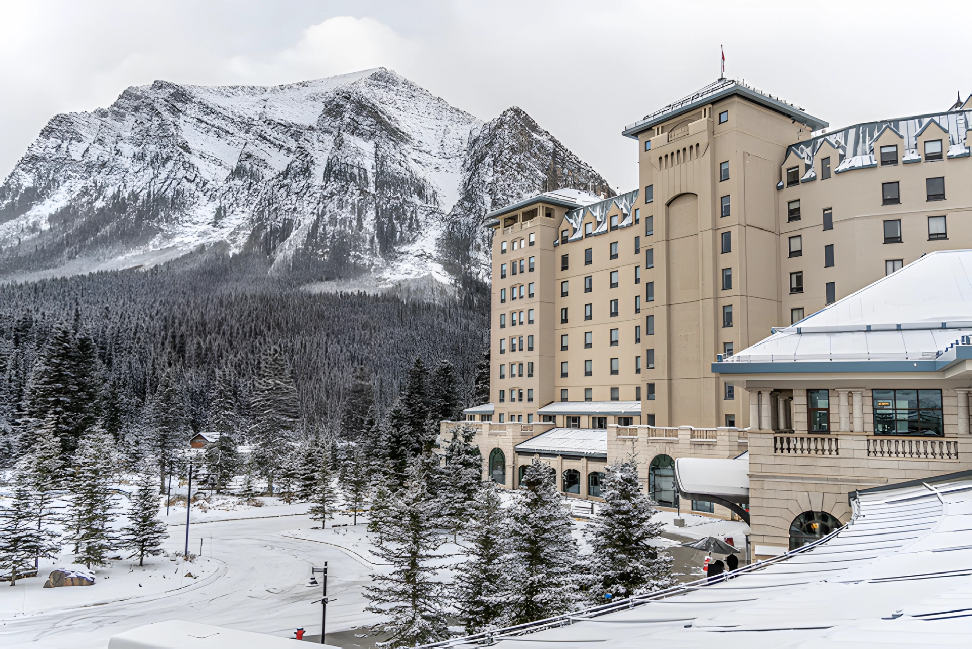 Historic hotel in Banff surrounded by snow and mountain views.
