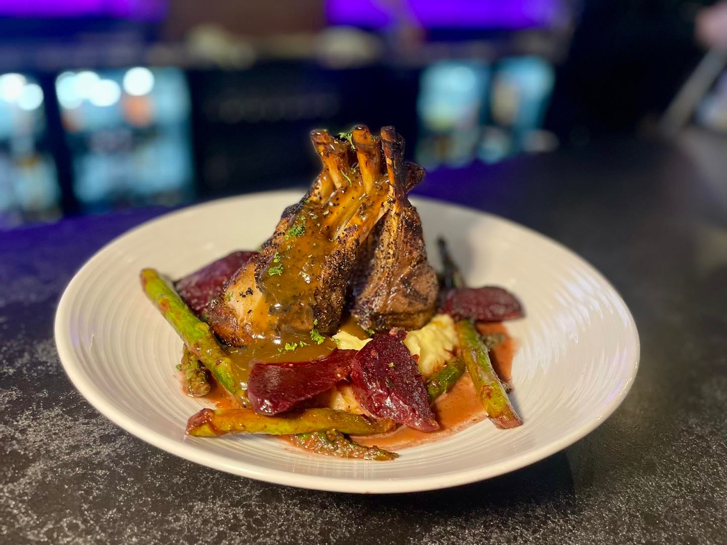 Rack of Lamb! Herb-crusted with garlic mashed potatoes gratin, asparagus and beets, and lamb sauce.