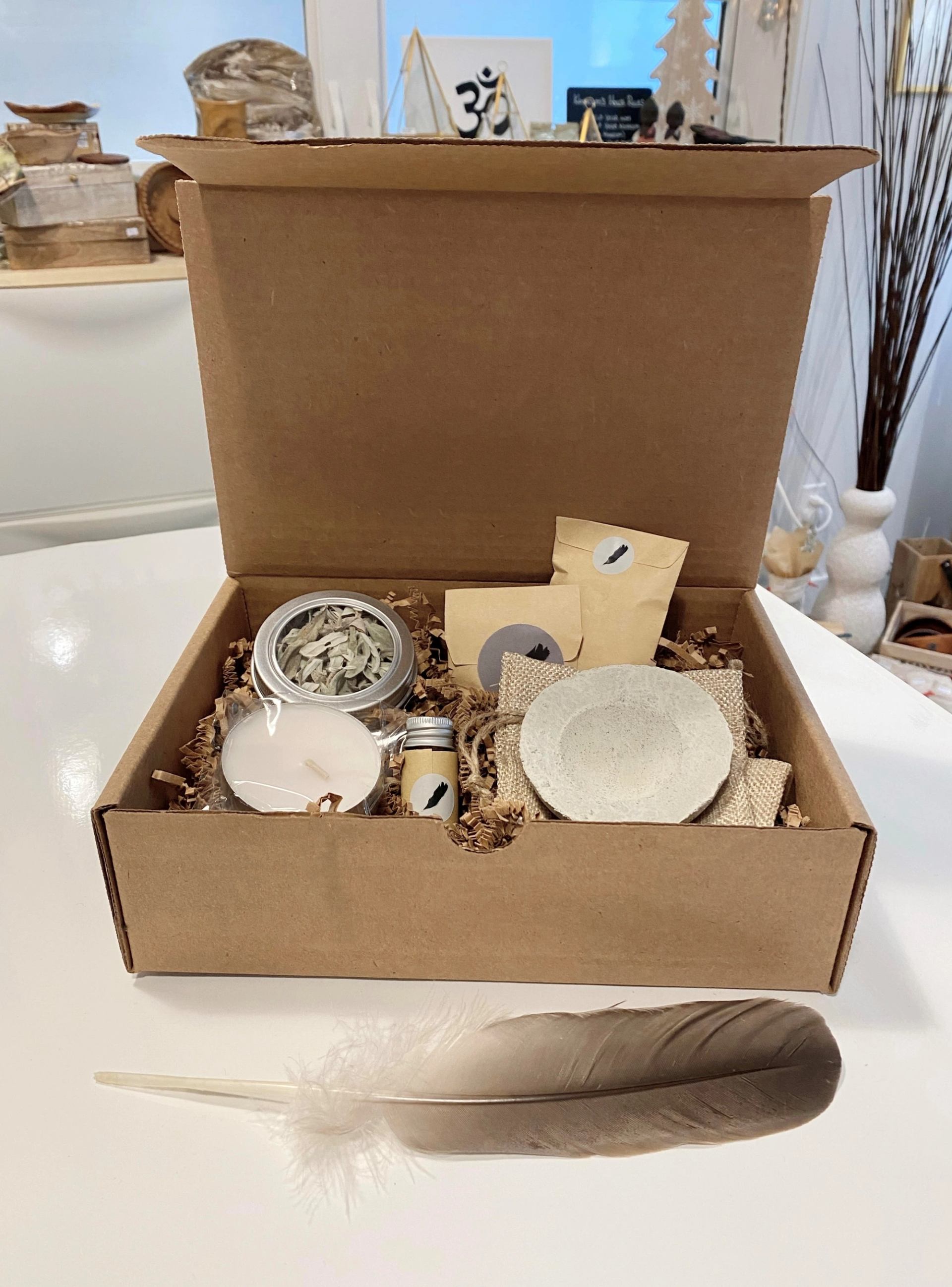 Handmade gift box with jars, soap, and paper packets on display in a shop.