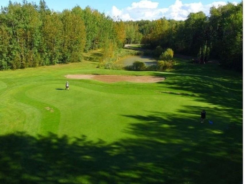 Gilwood Golf and Country Club course with golf green, sand trap, and trees in background.