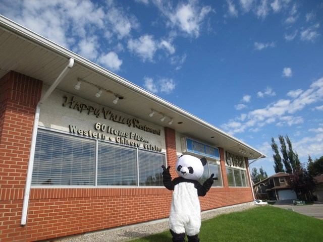 Happy Valley Restaurant exterior with panda mascot on grass.