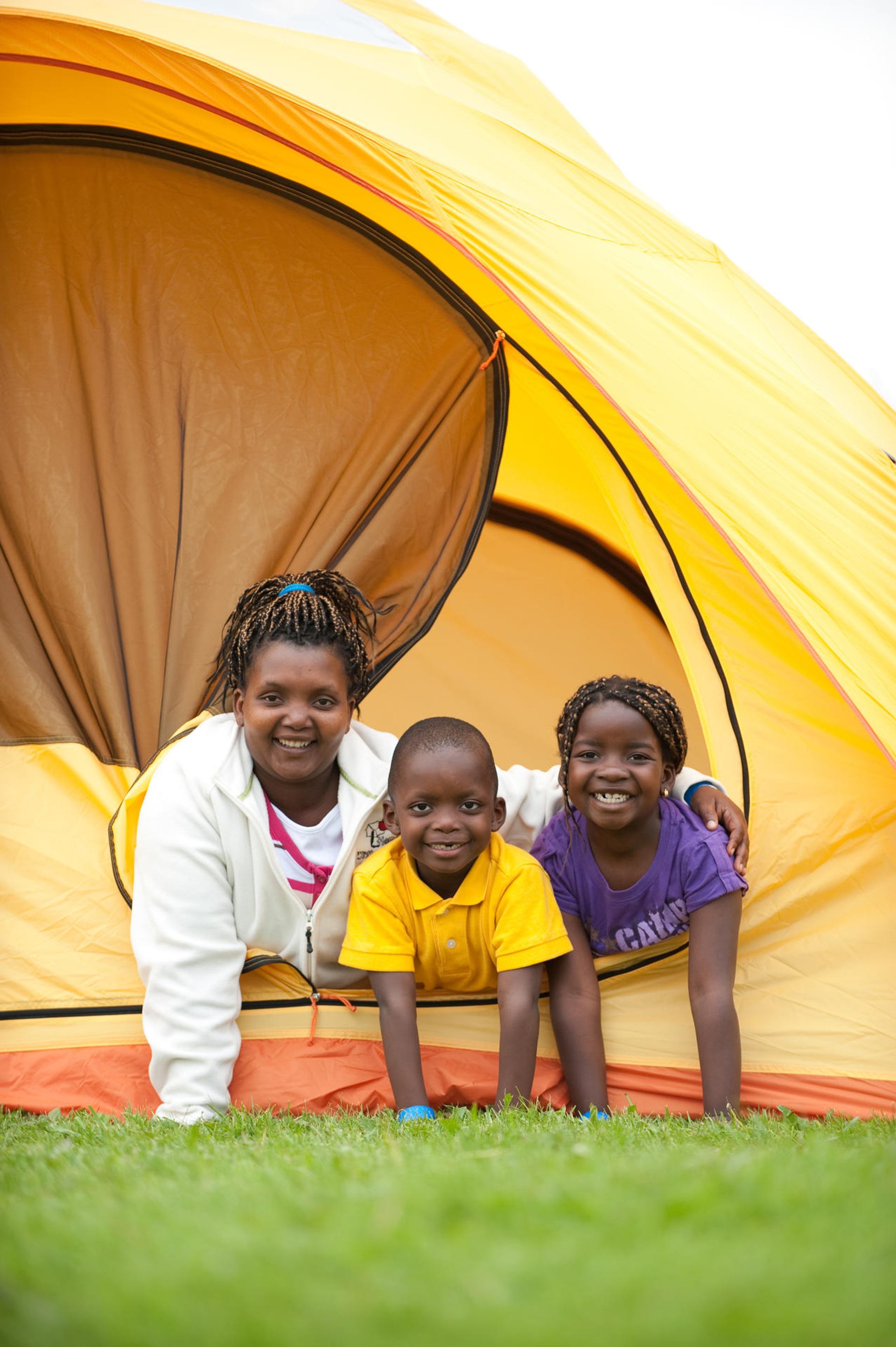 Three people inside a tent