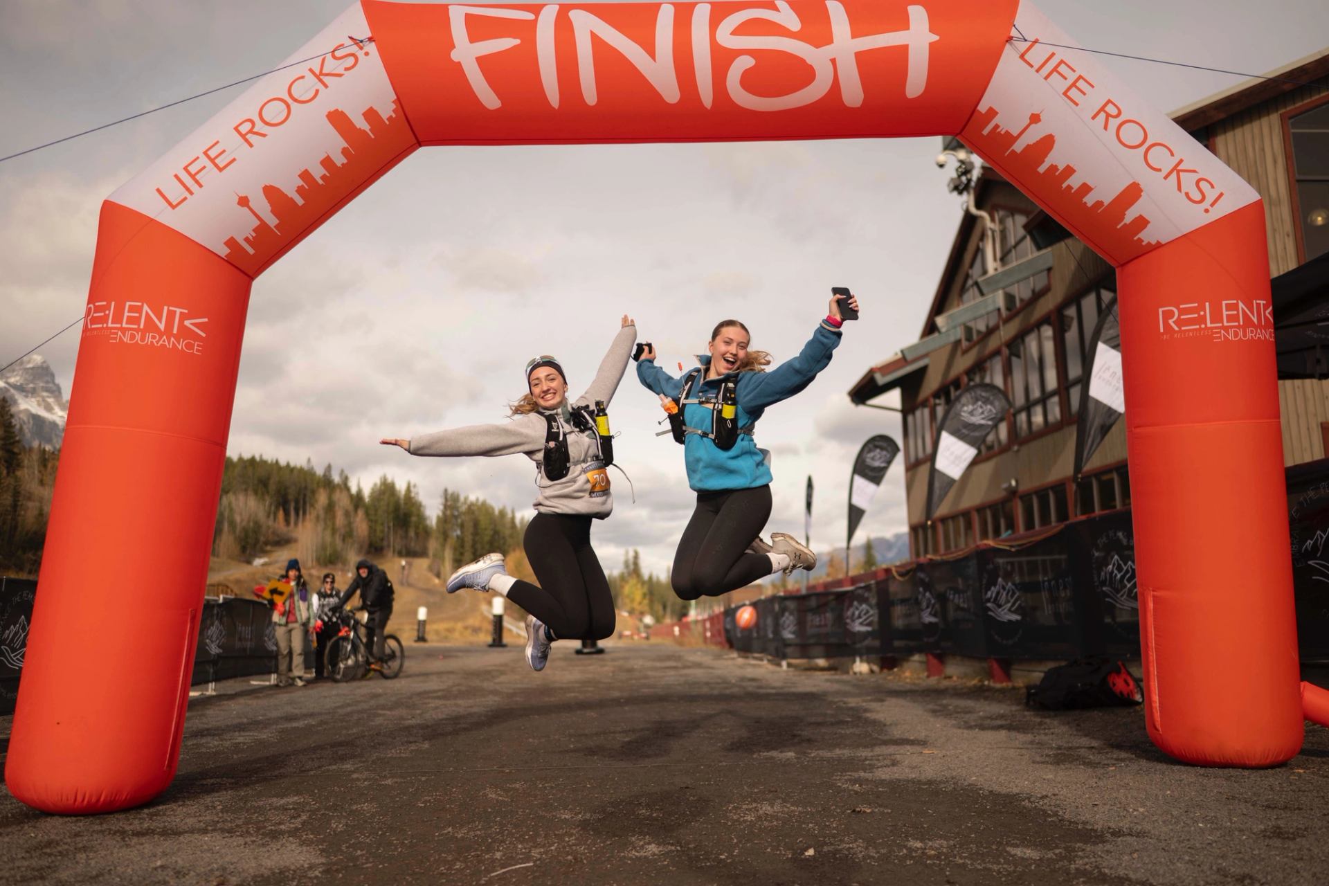Crossing the finish line with a leap of joy at the Sweater Weather 10K & 5K Trail Race!