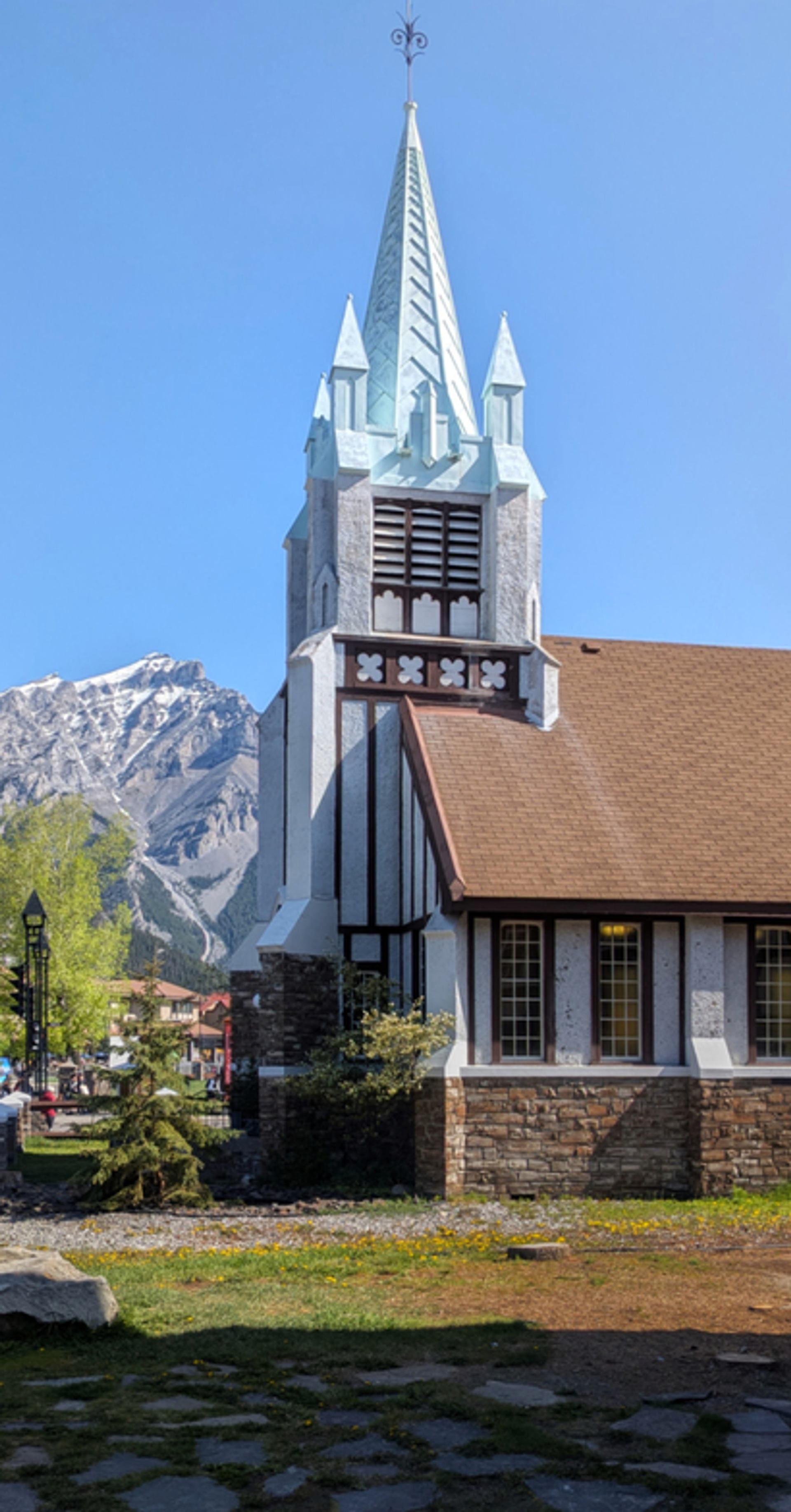 St. Paul's Presbyterian Church features a tall steeple with mountains rising in the background.