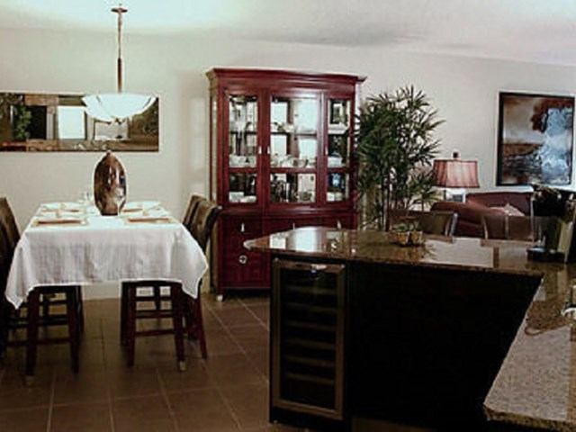 Elegant dining area with dark wood furniture and granite counter at Corporate Suites of Calgary.