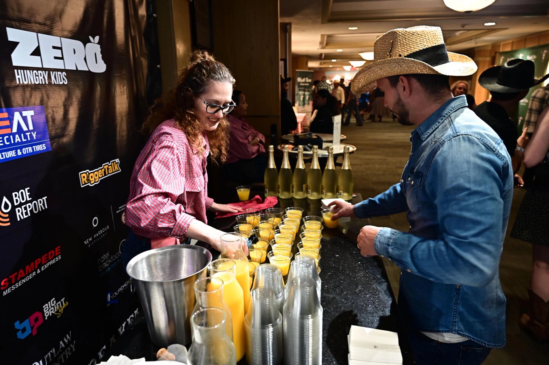A lady serving up orange juice