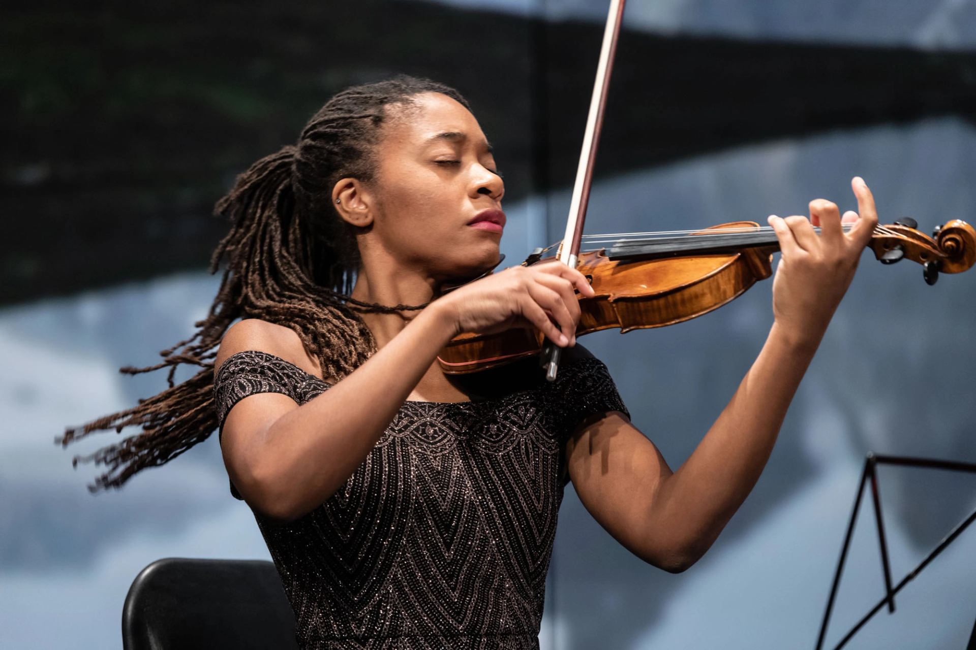 A violinist plays on stage