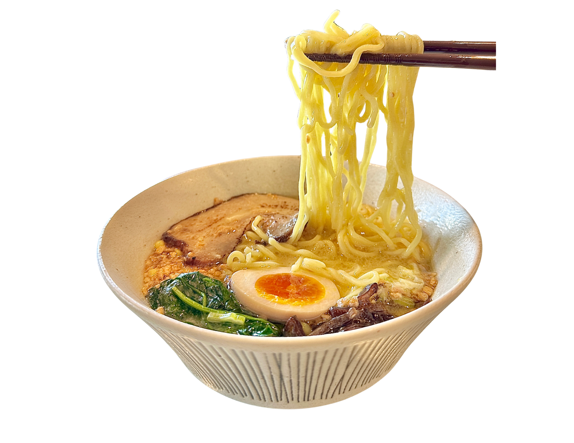 Chopsticks lift noodles from ramen topped with egg, pork and greens.
