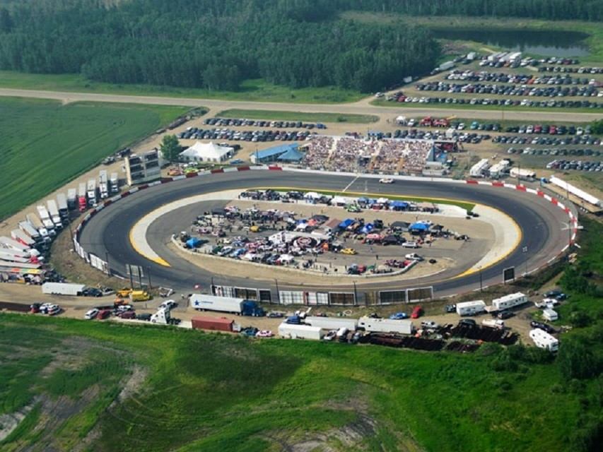 Aerial shot of NASCAR Canada NAPA 300 oval track with grandstands and surrounding parking.