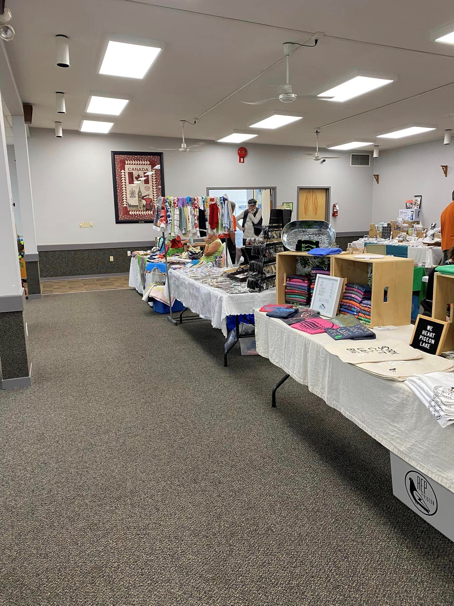 Indoor vendor tables with handmade crafts and clothing at Mulhurst Bay Farmers’ Market.