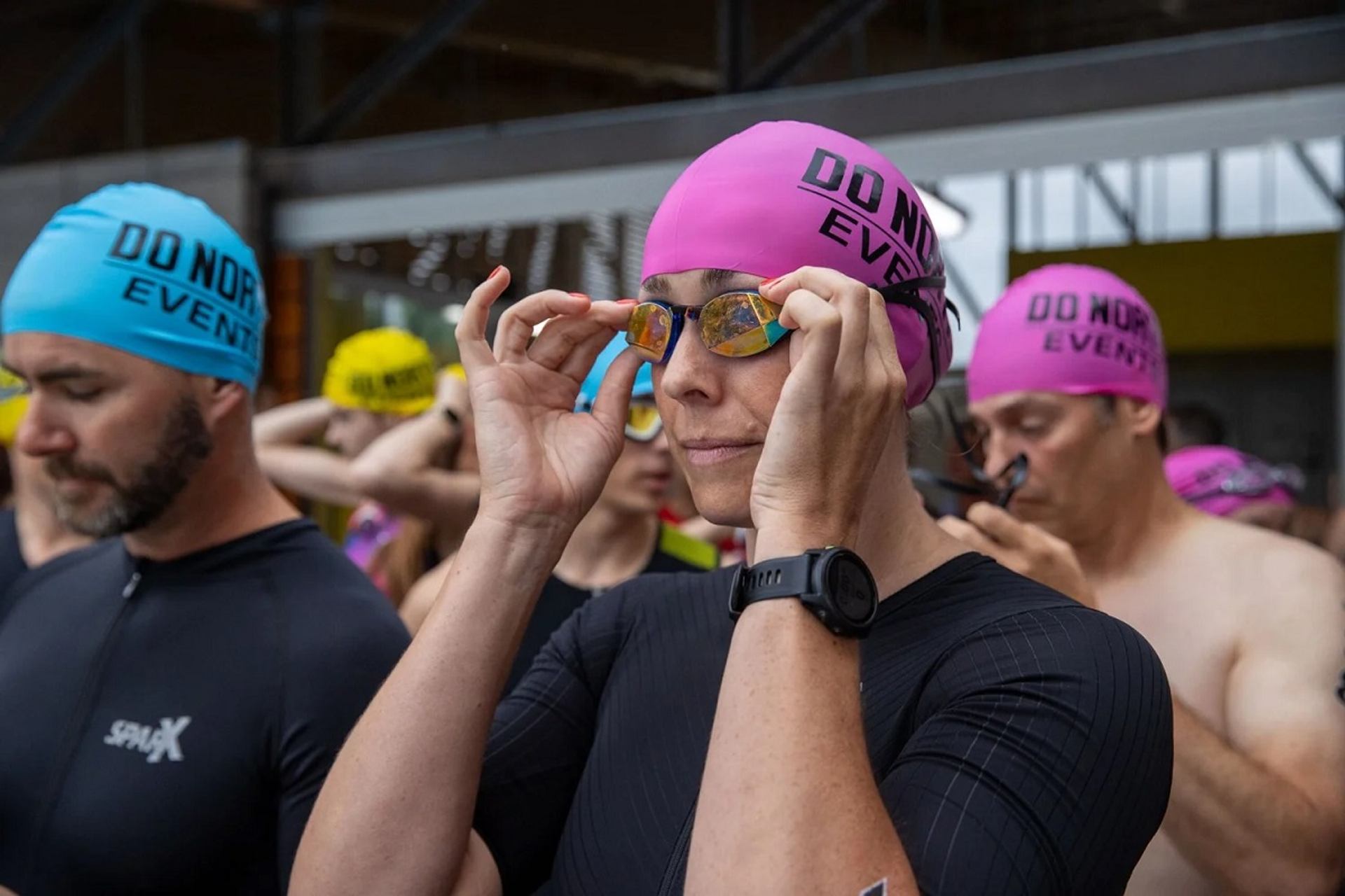 Athletes in swim caps ready to race at Do North Tri & Trail.