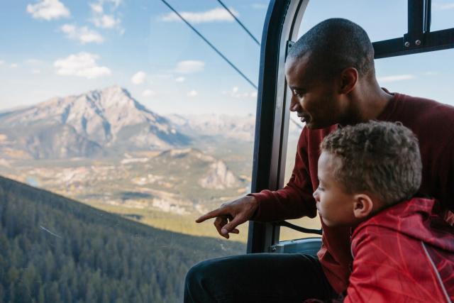 Father and son looking out of the Gondola.