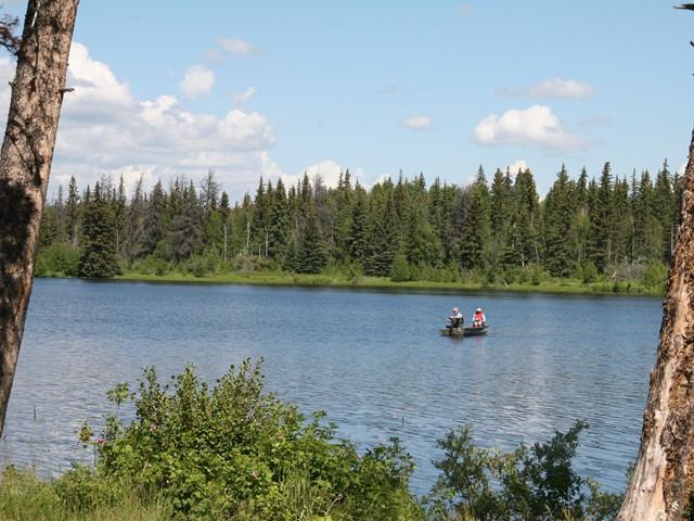 Two people in a boat on the lake.