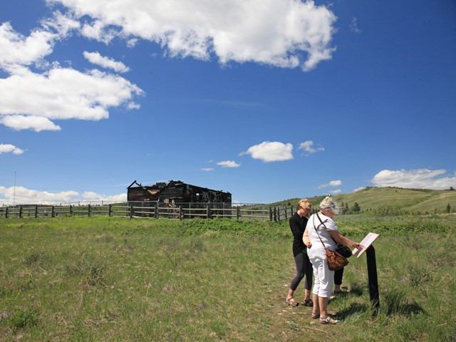 Visitors looking at an informative plaque.