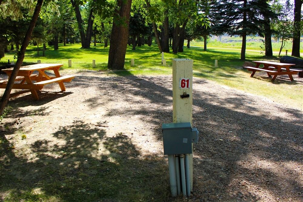 Campsite with picnic tables and electrical hookup at Taber Municipal Park.