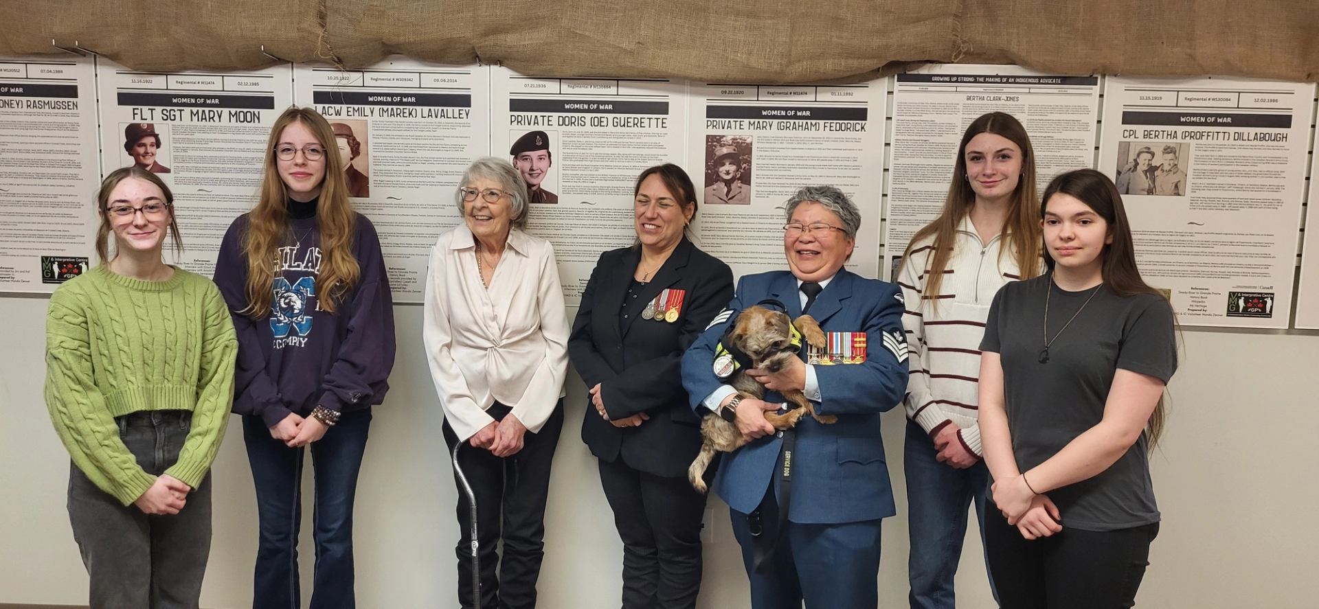 People standing in front of informational panels about veterans