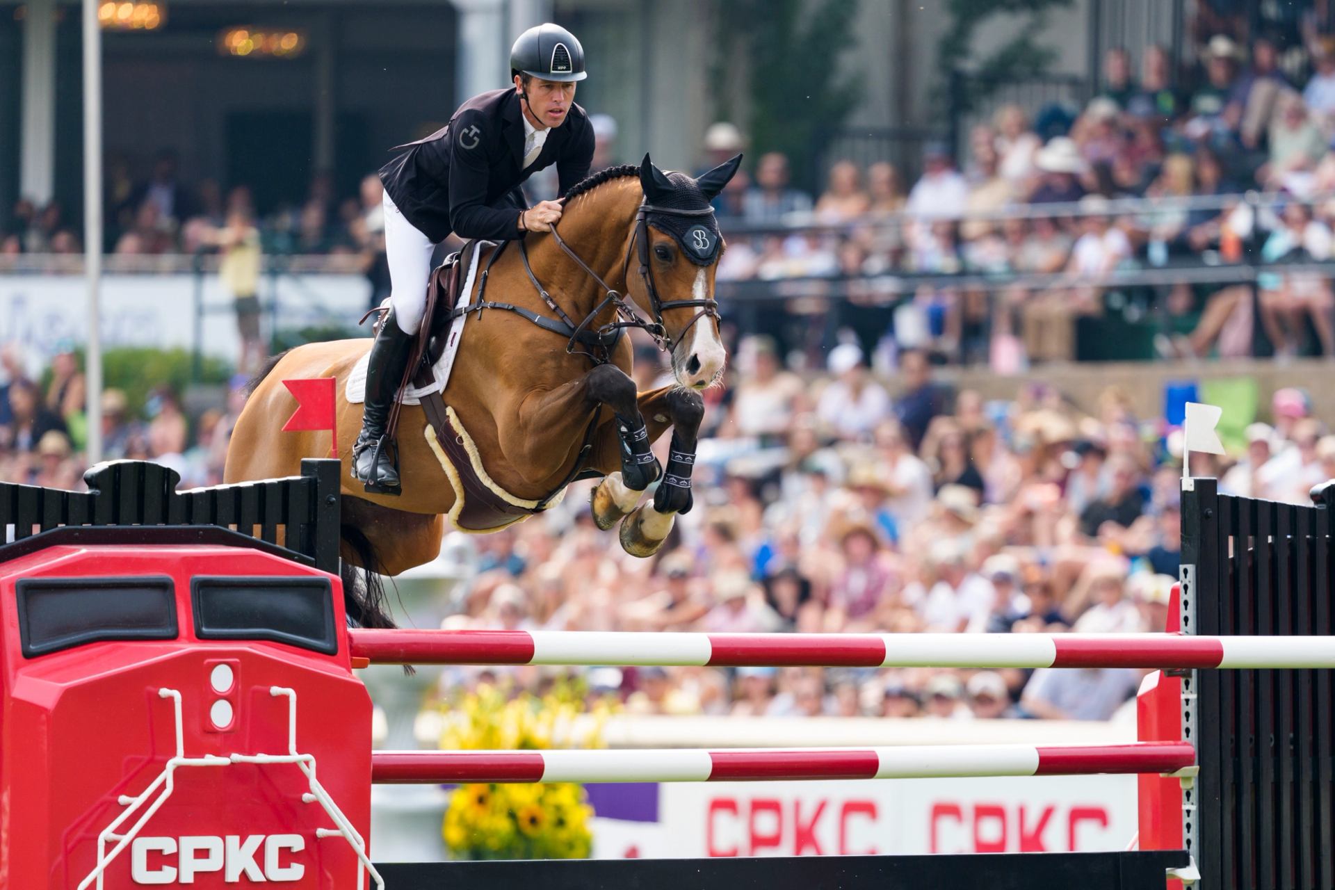 Horse and rider jumping a high obstacle during the ‘Masters’ Tournament at Spruce Meadows.