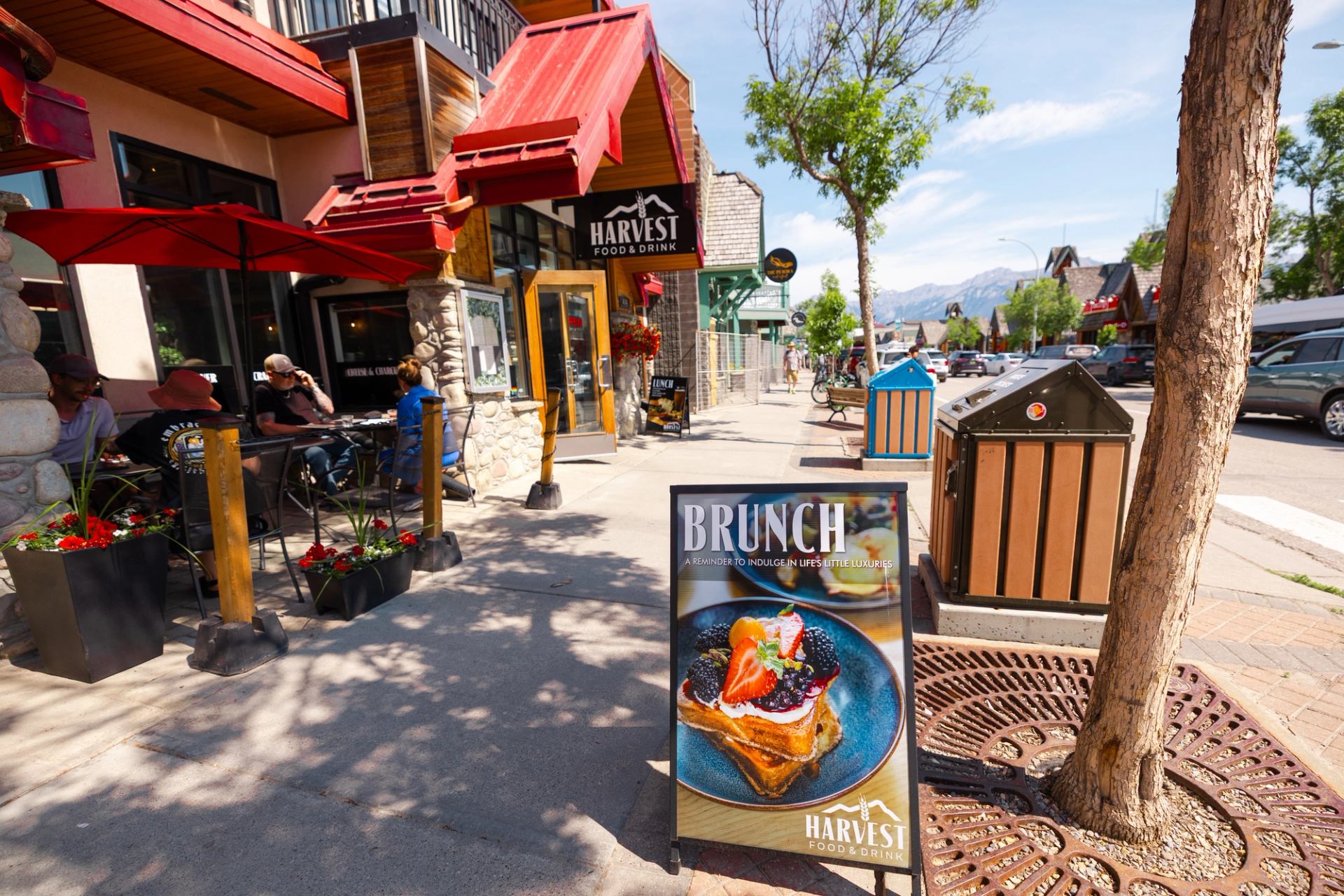 Outdoor view of Harvest with a brunch sign and plated dish on the sidewalk.