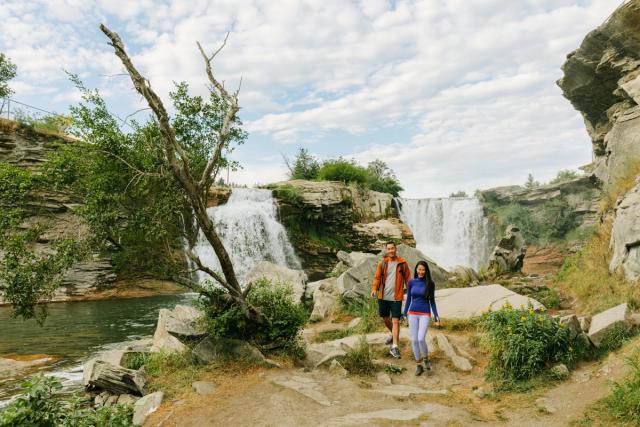 Couple exploring and enjoying Lundbreck Falls.