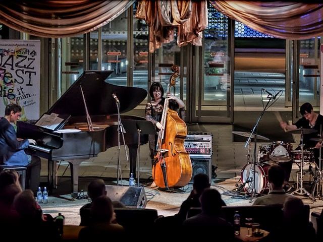 Jazz trio performs with piano, upright bass, and drums at Medicine Hat JazzFest.