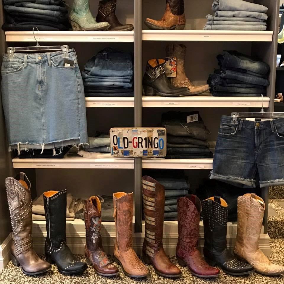 Shelving displays jeans and cowboy boots, with a “OLD GRINGO” license plate sign.