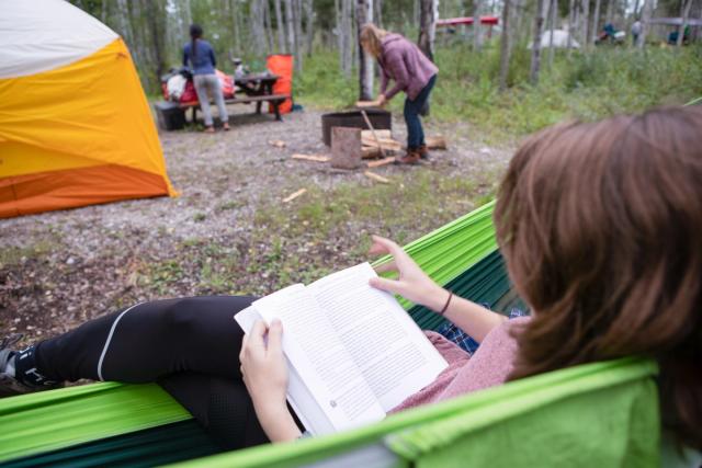 Women reading a book in a hammock at Pine Lake Campground.