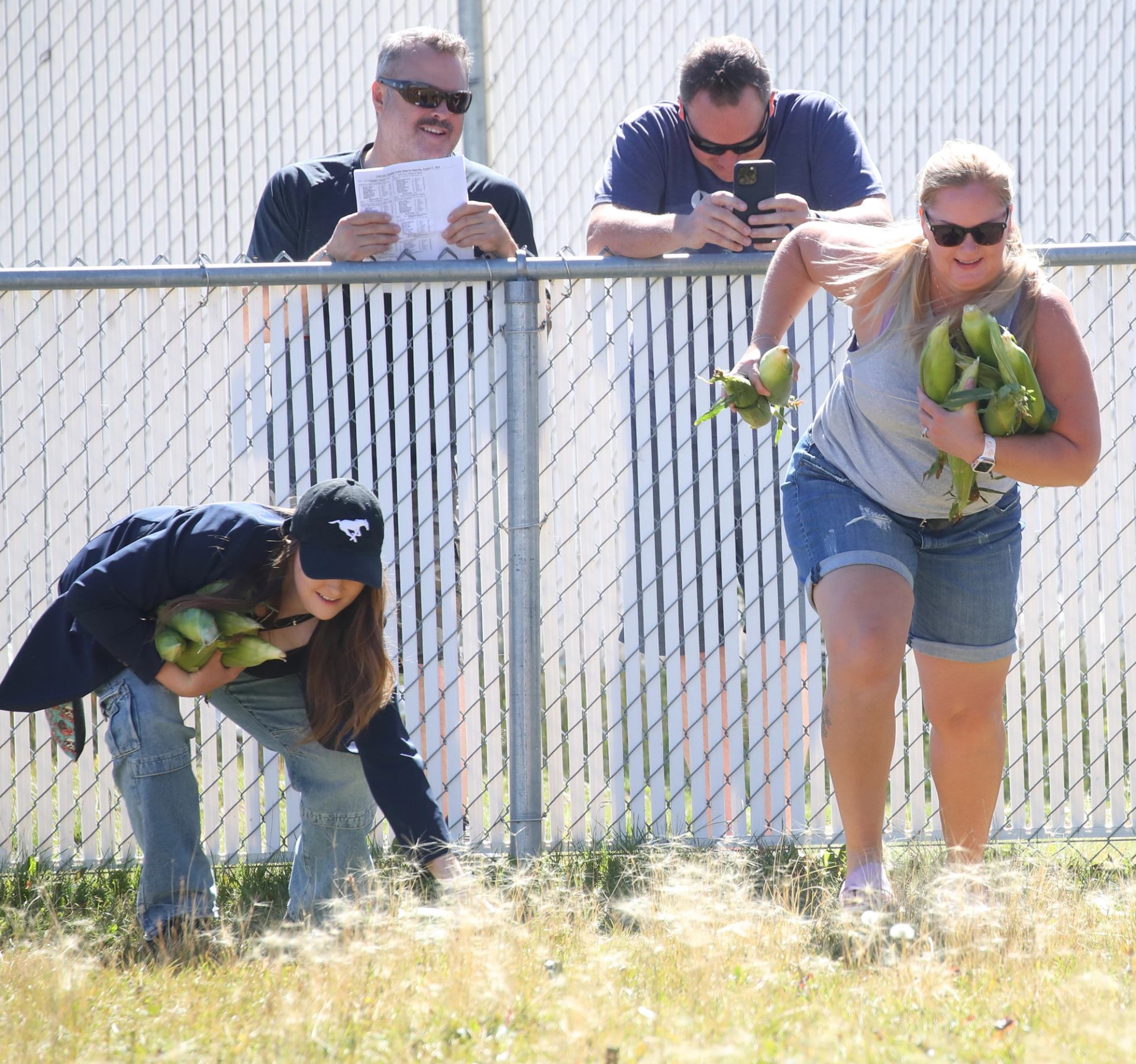 Participants race while carrying ears of corn
