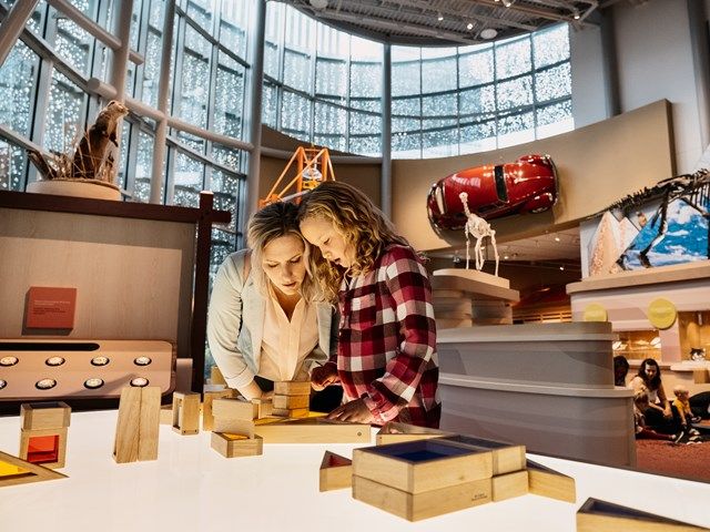 Mother and duaghter exploring an interactive exhibit at the Royal Alberta Museum.