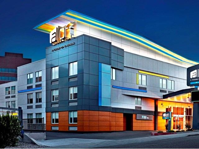 Night view of Aloft Calgary University Hotel with modern design and lit entrance.