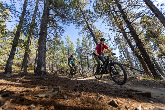 Couple biking the trails of Bragg Creek.