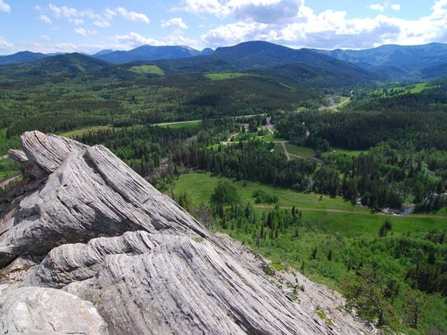 Elevated view of forested hills and valleys from a rocky lookout point