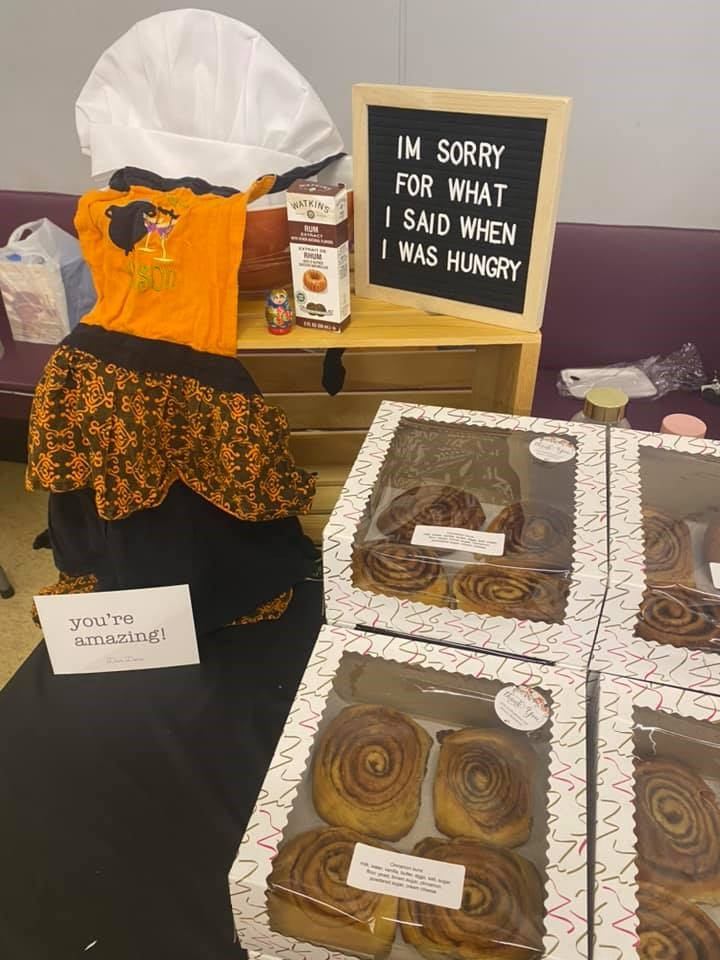 Cinnamon rolls and Halloween-themed mannequin at Andrew Farmers' Market.