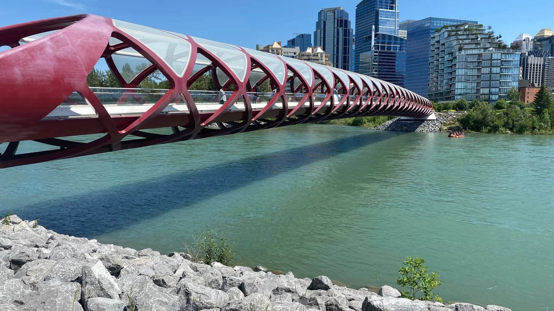 Peace Bridge crossing a blue river with Calgary’s skyline in the background.