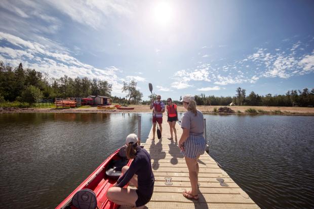 Couple getting ready go canoeing on Astotin Lake.