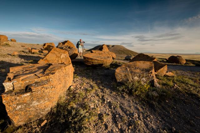 Man taking photos at Red Rock Coulee.