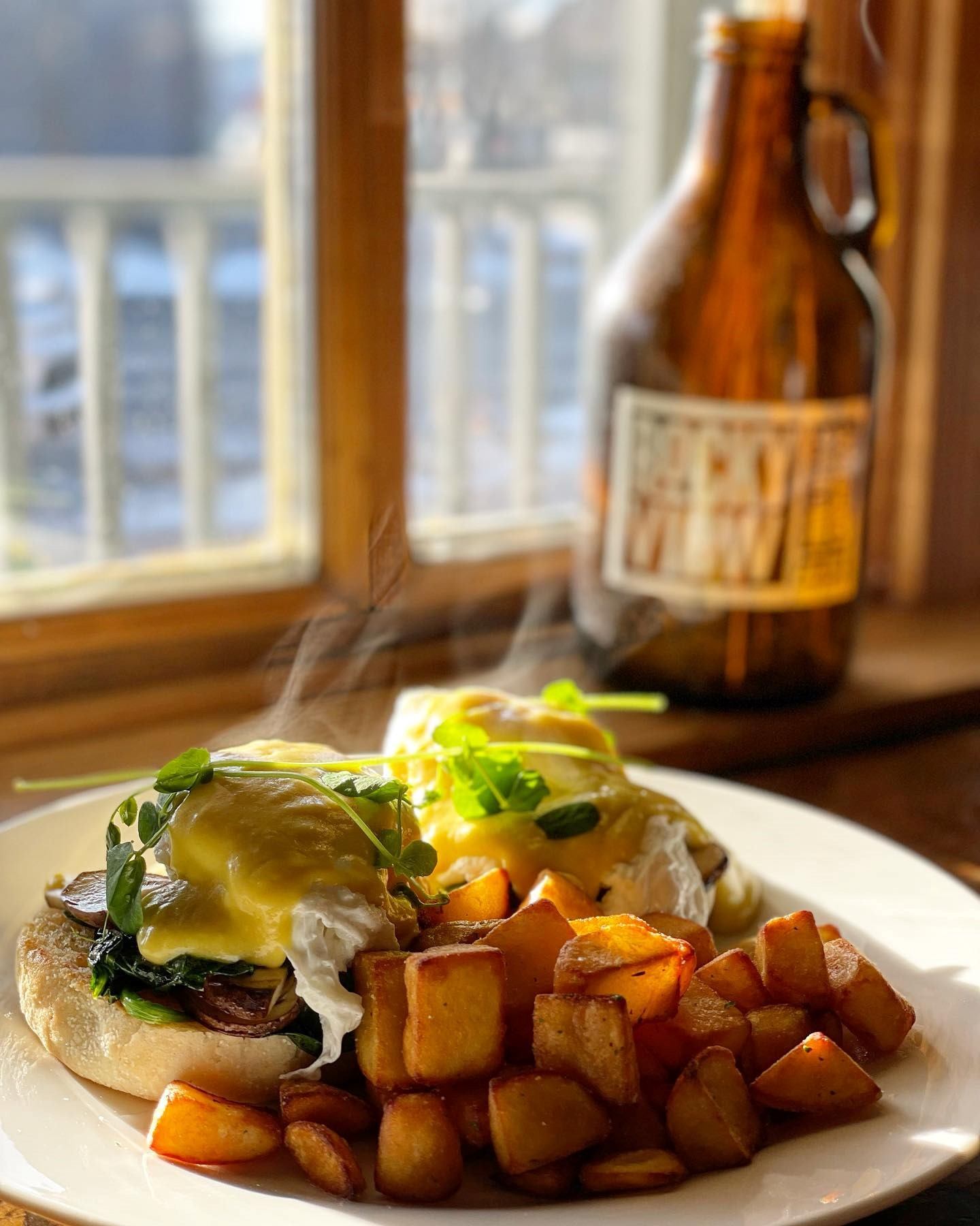 A plated burger set in from on a window with a Rocky View Brewing Company growler beside it.