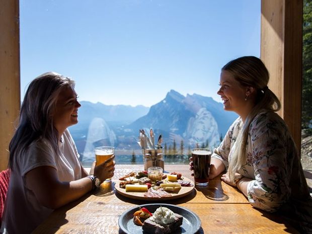 Friends enjoying a meal at the top of Mt Norquay.