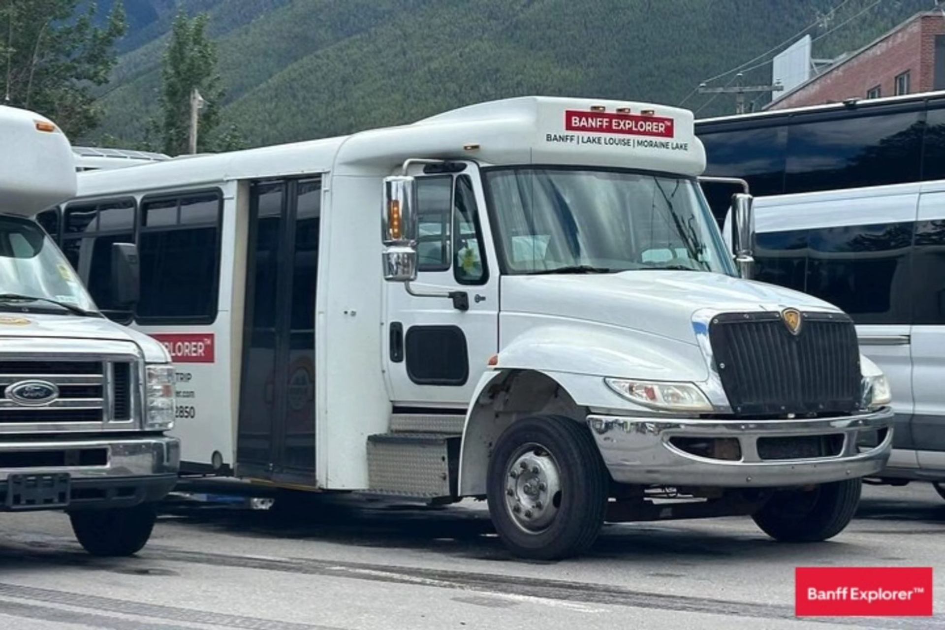 : Banff Explorer bus parked along a mountain town street