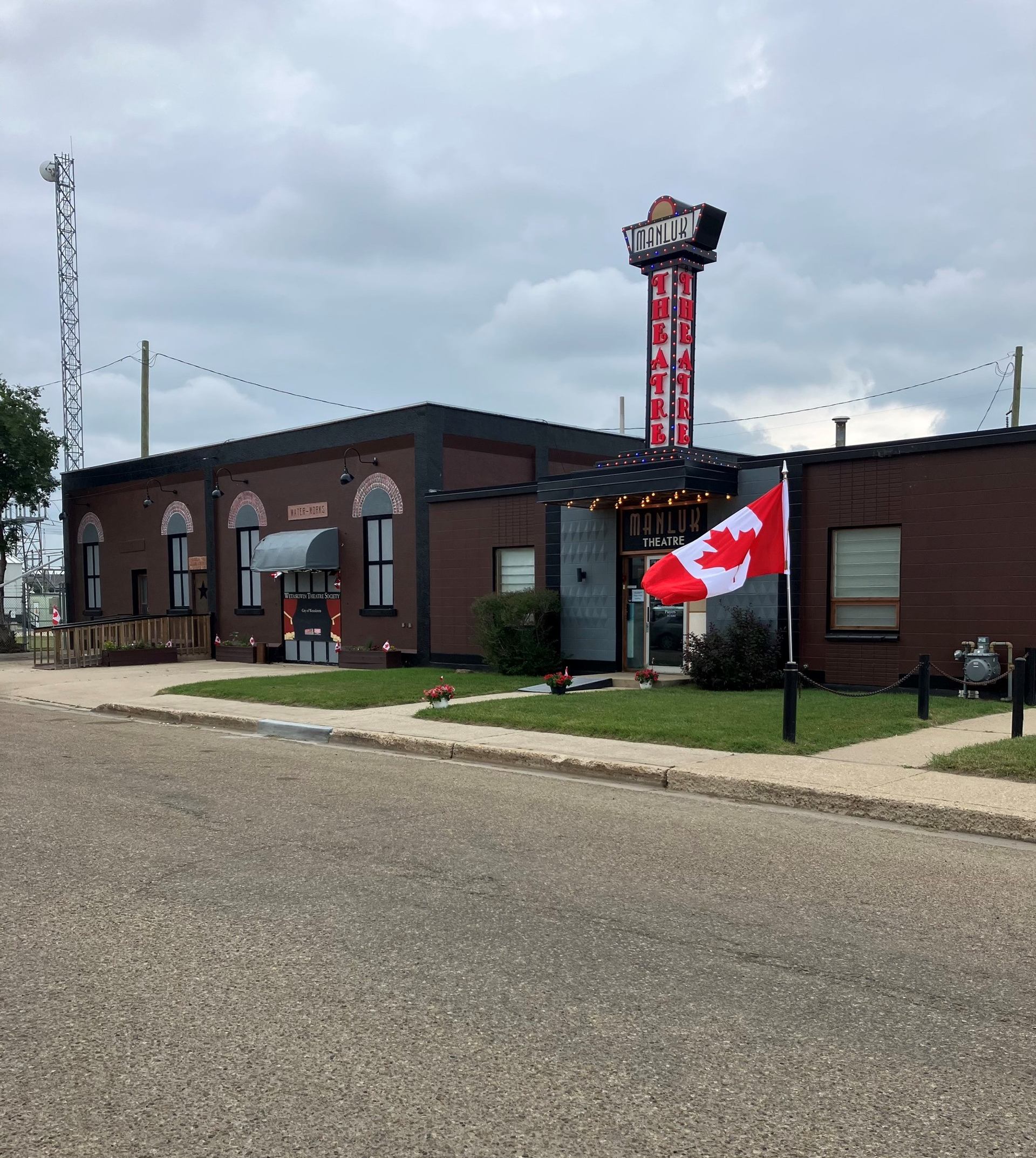 Manluk Theatre exterior with marquee sign and Canadian flag.