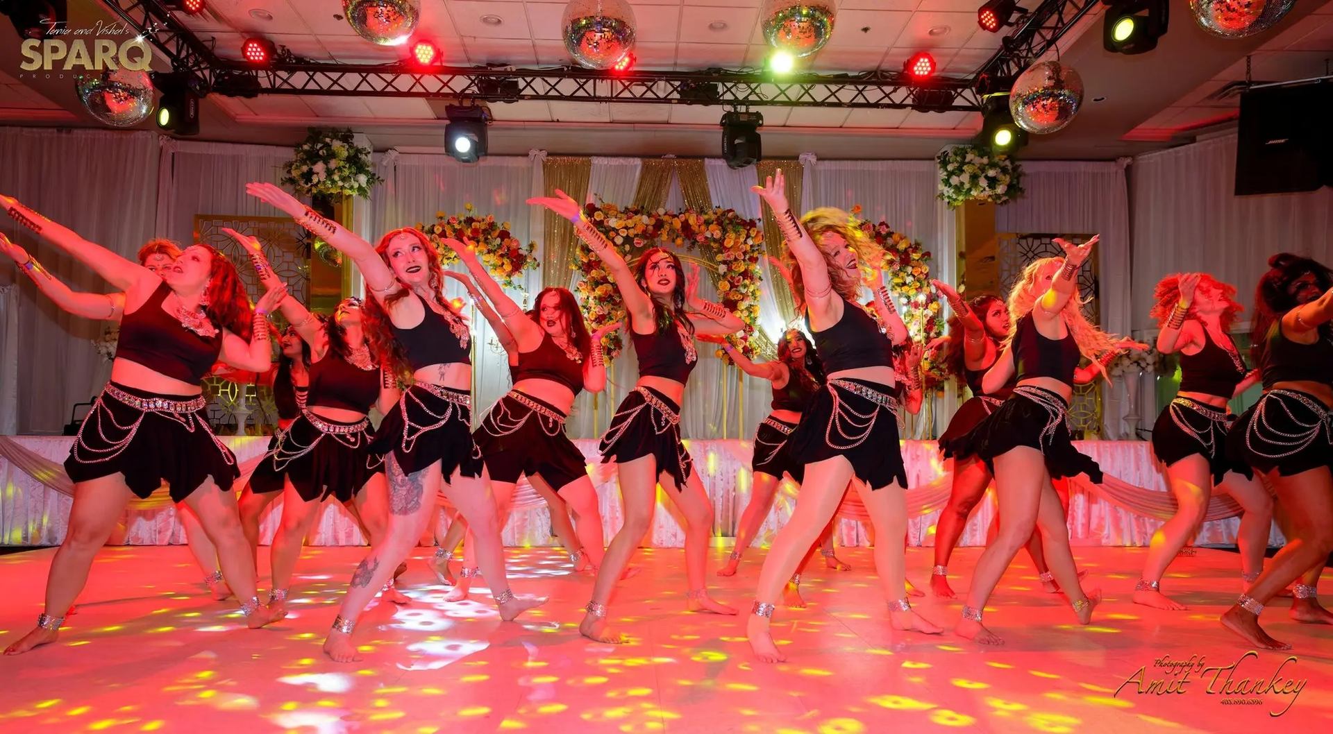 Group dance with vibrant lights at Diwali Dhamaaka.