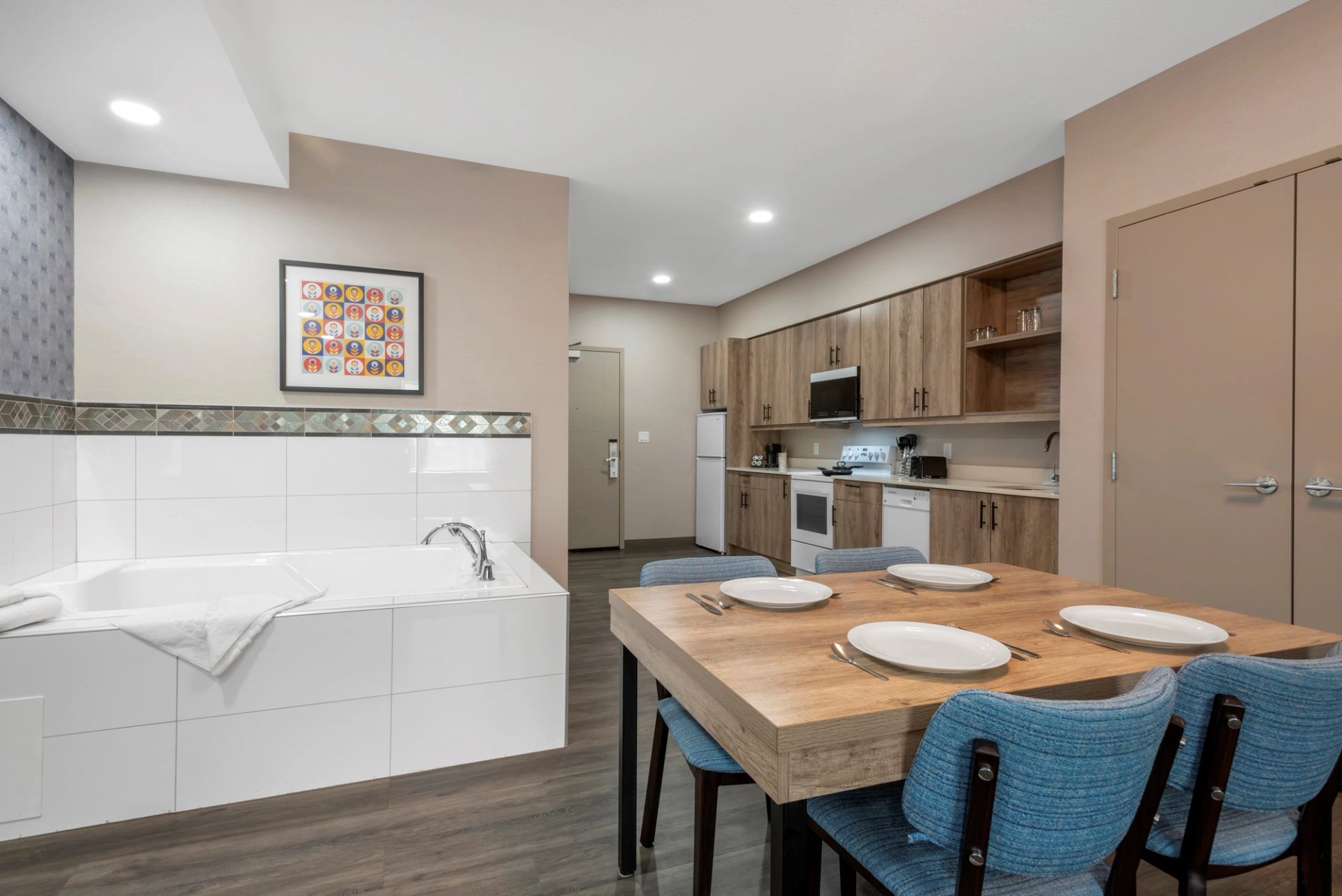 Stylish kitchen-dining area with bathtub and modern decor.