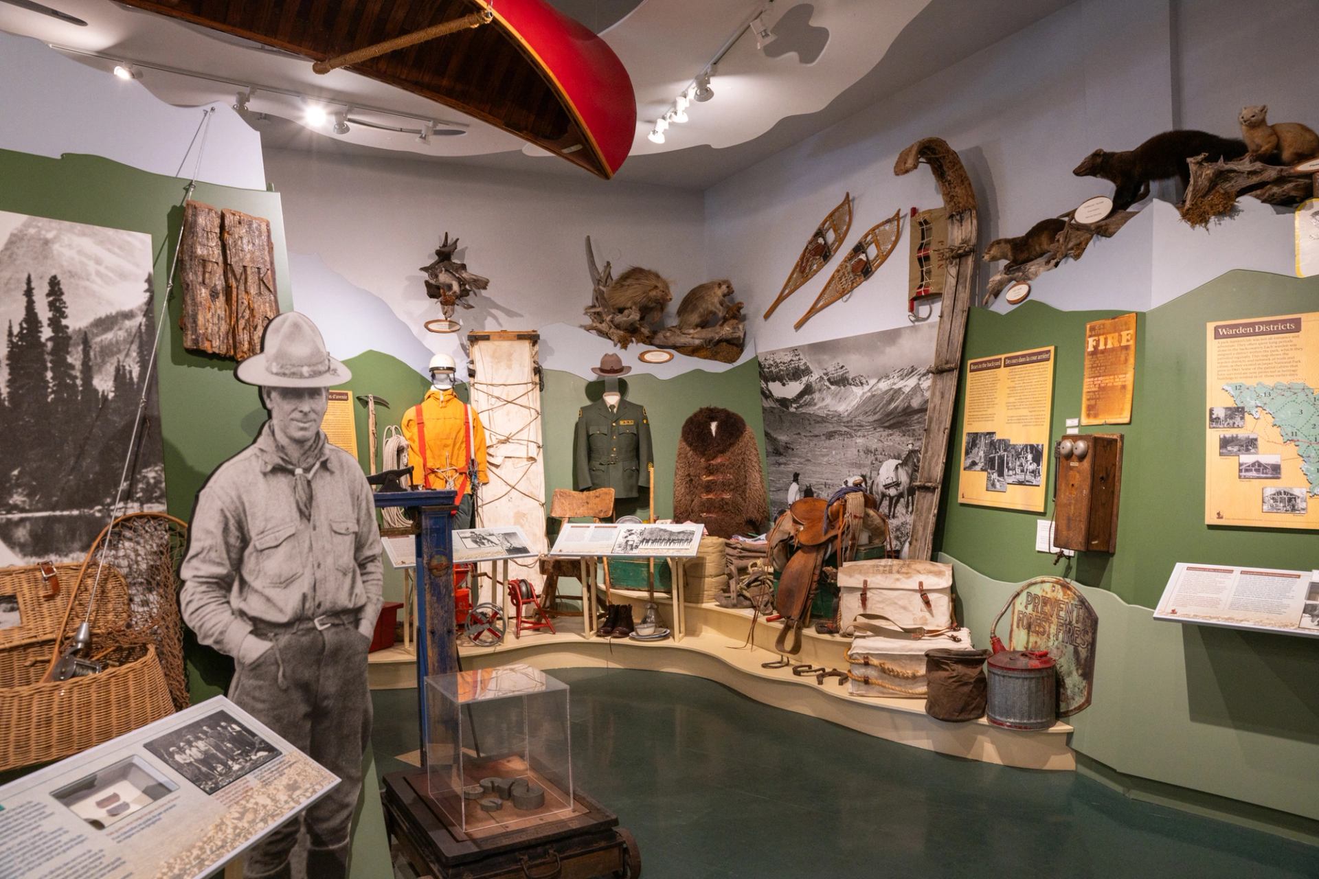 Exhibit at Jasper Yellowhead Museum with artifacts and mannequins in period clothing.
