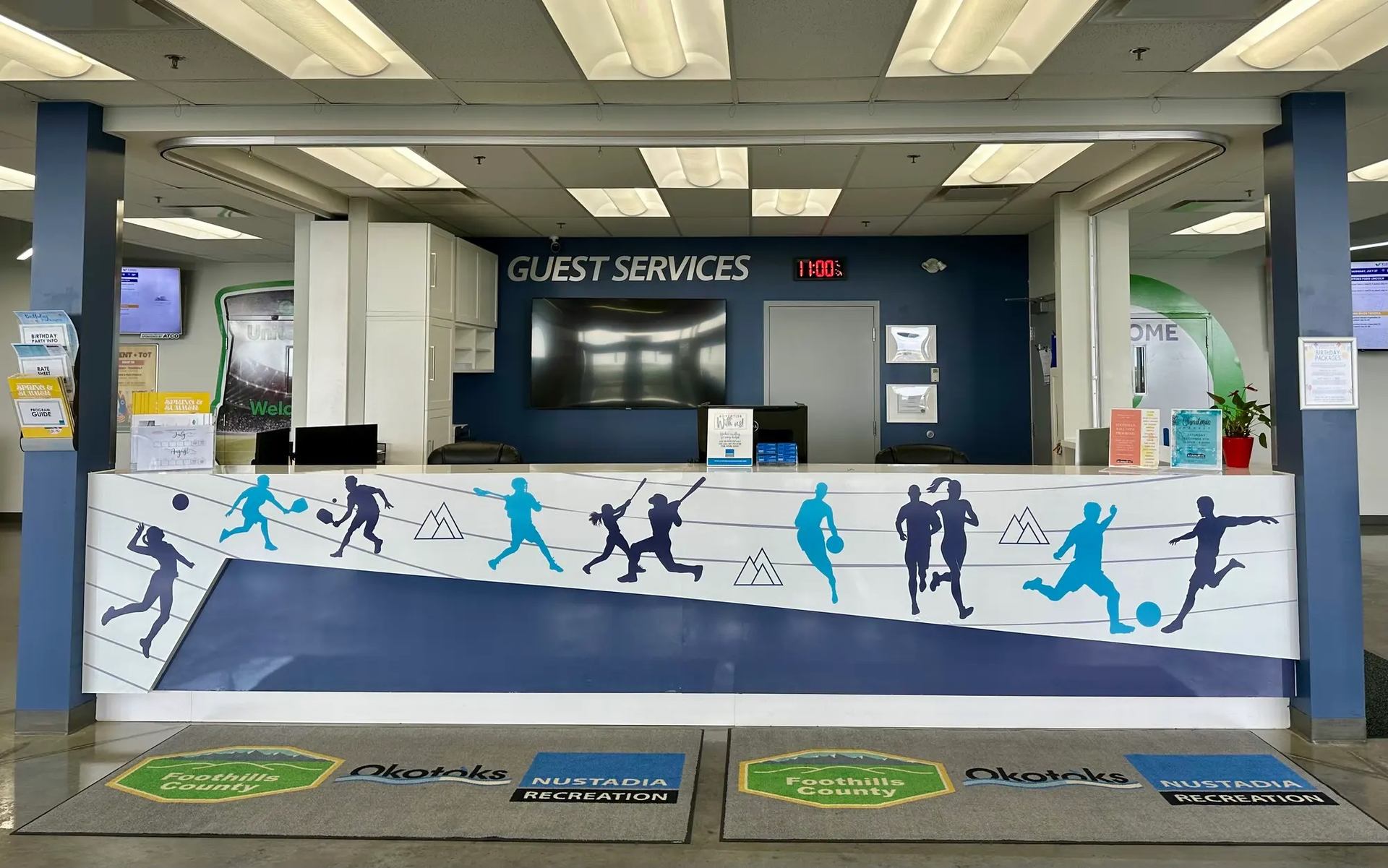 Guest Services counter at Regional Field House with sports-themed decor.