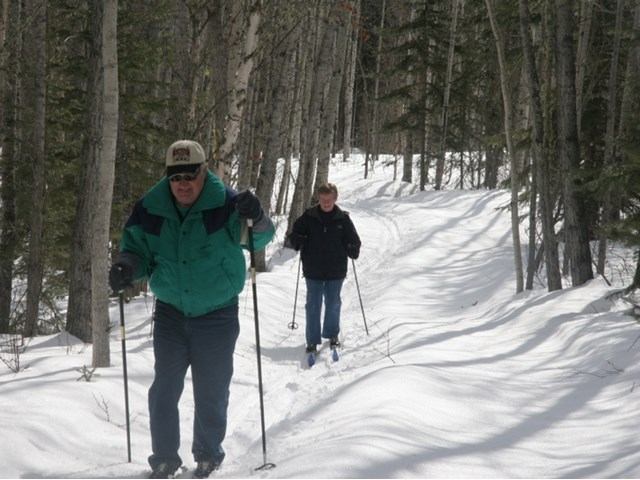 Two people cross country skiing
