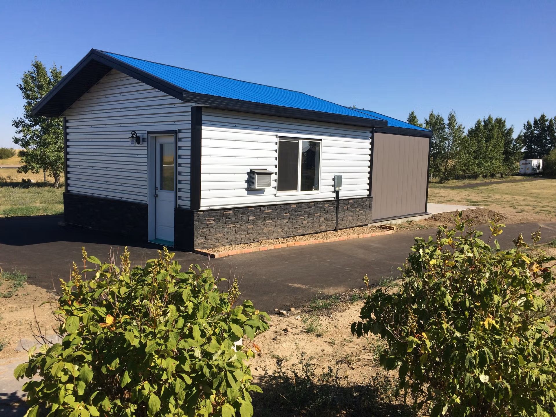 Small observatory with blue roof and white siding.