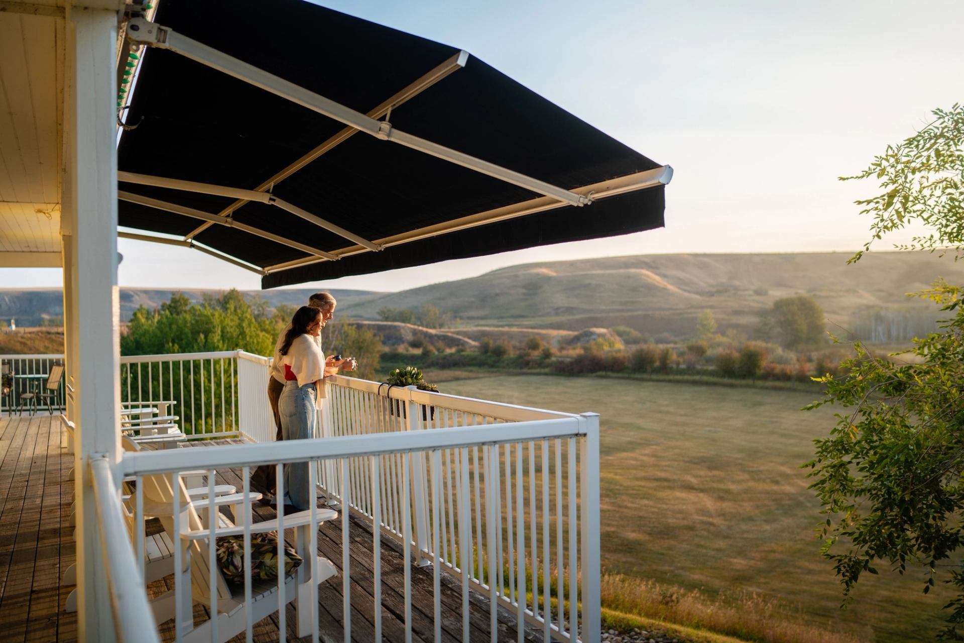 A couple enjoys coffee during sunrise at the Rosebud Country Inn.