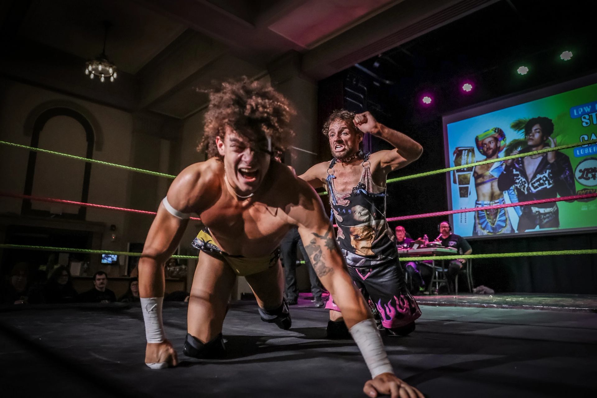 Wrestler on the mat as opponent stands during Love Pro Wrestling 44 bout
