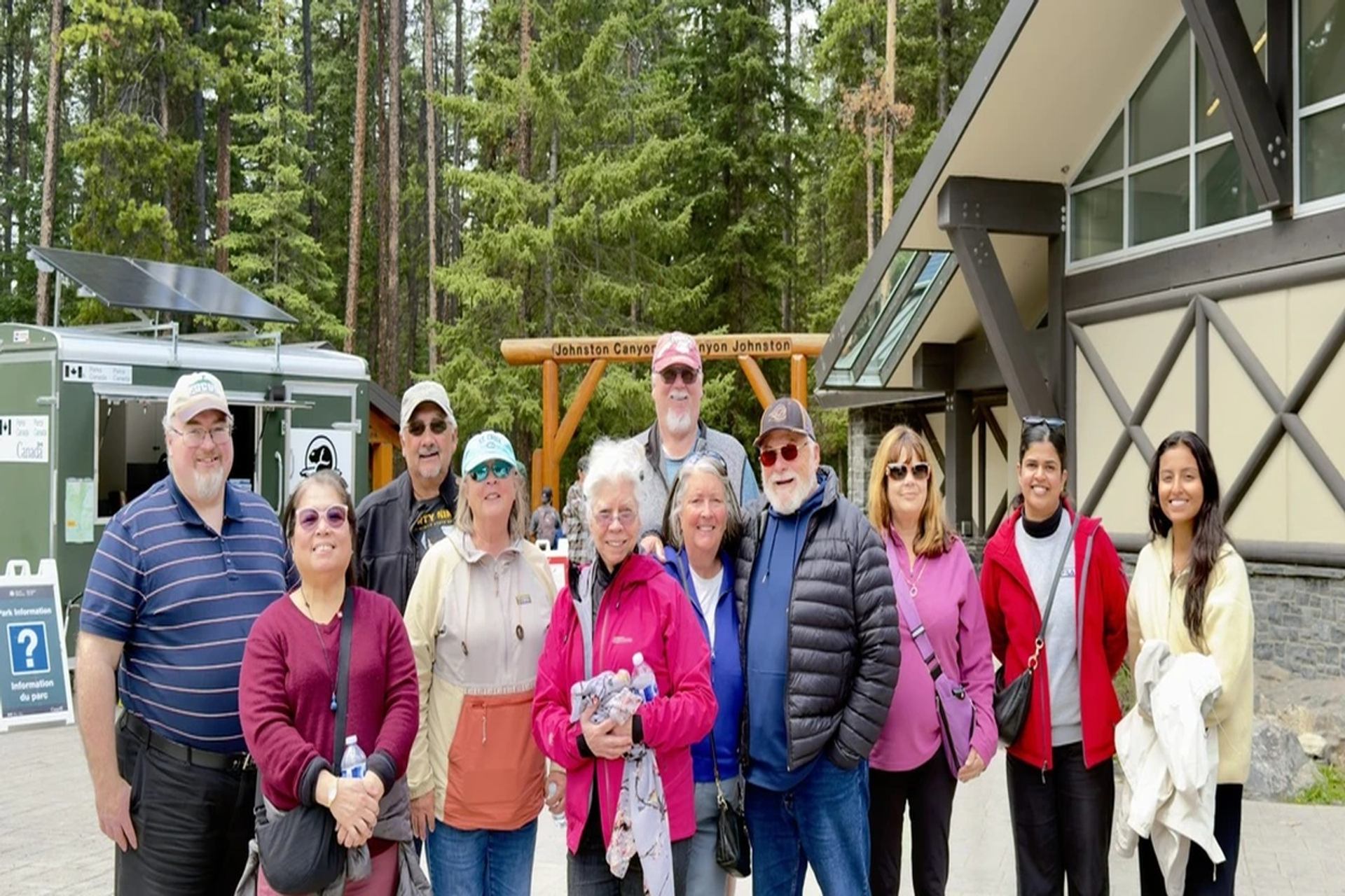 Group of people posing outside the Johnston Canyon visitor centre.