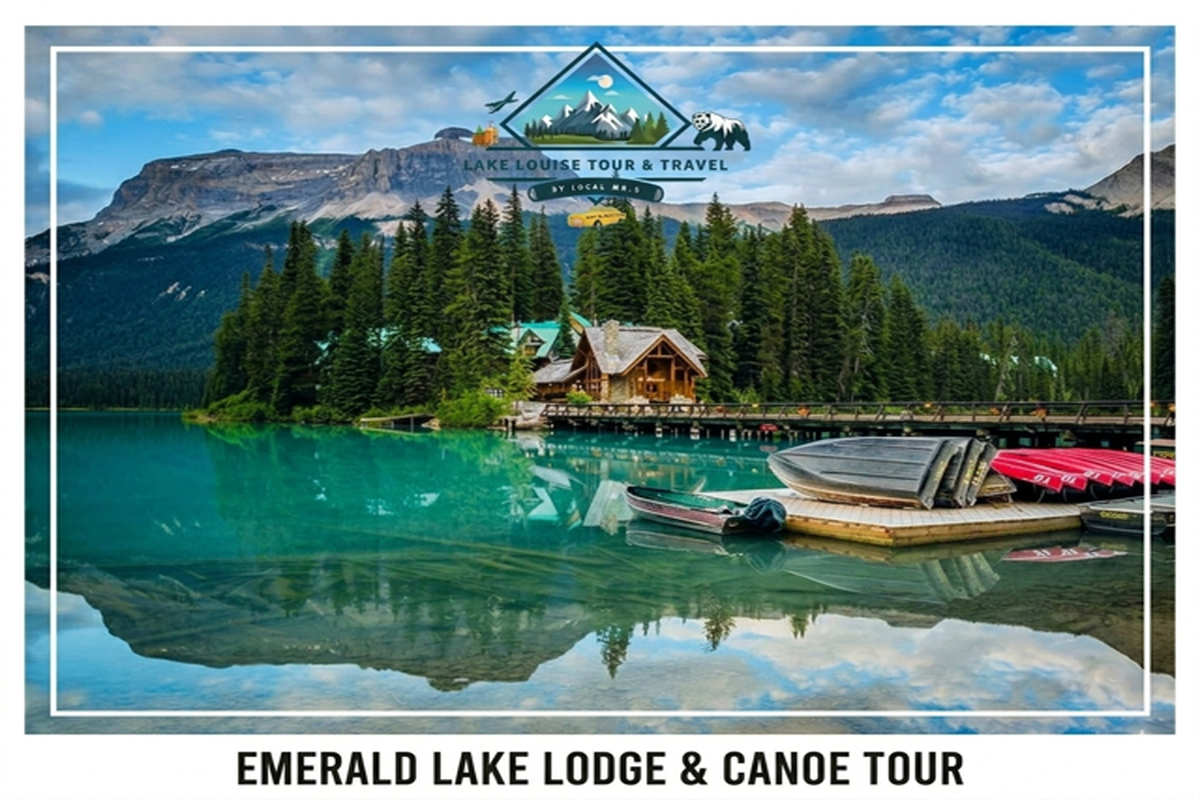 Emerald Lake lodge beside turquoise water with docked canoes, forest and mountains in background